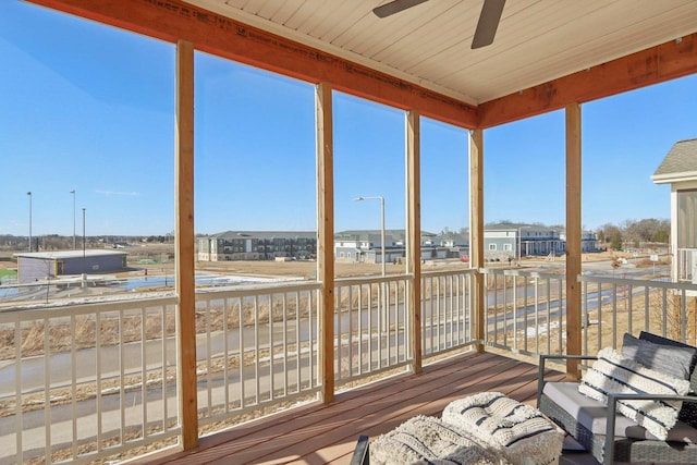 unfurnished sunroom featuring ceiling fan