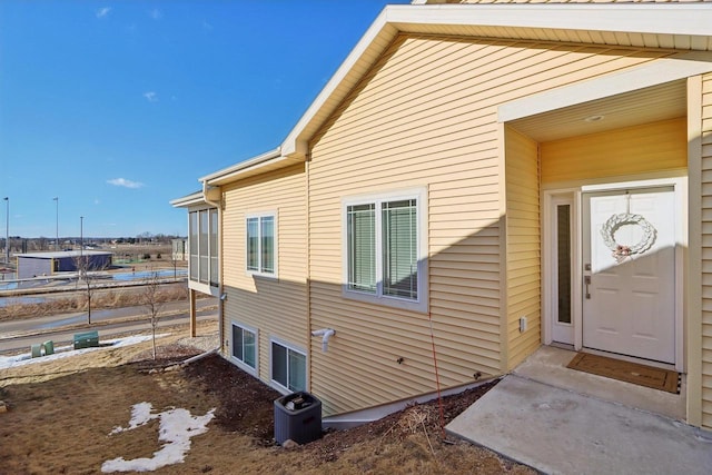 view of side of property featuring central AC