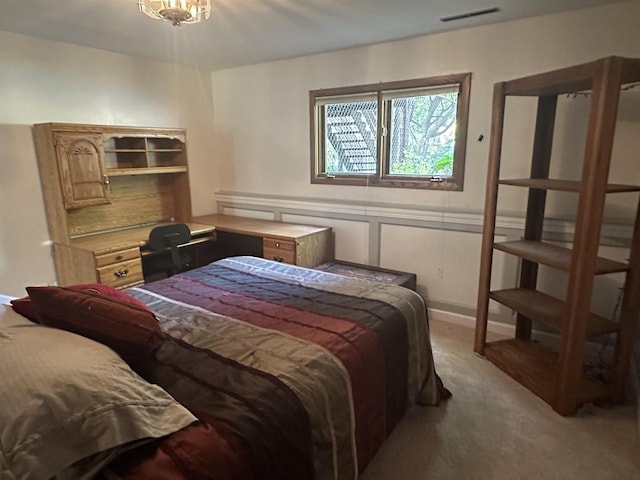 bedroom with a wainscoted wall, visible vents, a decorative wall, and light colored carpet