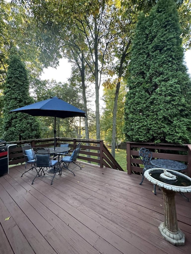 wooden deck featuring outdoor dining space