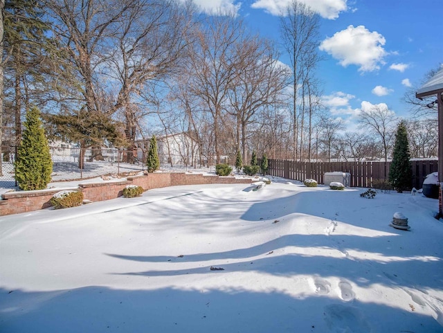 yard covered in snow with fence