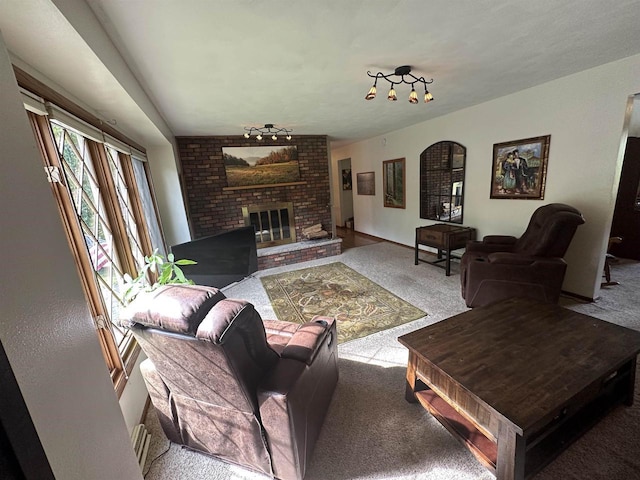 living area featuring a brick fireplace and carpet flooring