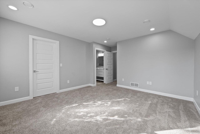 unfurnished bedroom with recessed lighting, visible vents, carpet flooring, vaulted ceiling, and baseboards