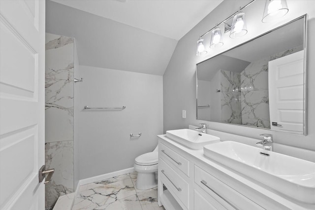 bathroom featuring vaulted ceiling, a marble finish shower, a sink, and toilet