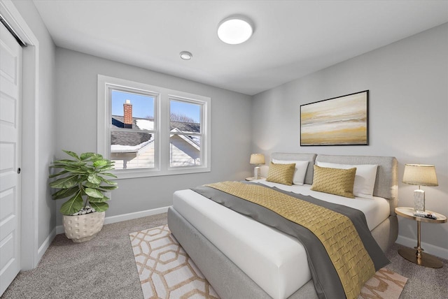 bedroom featuring light carpet and baseboards