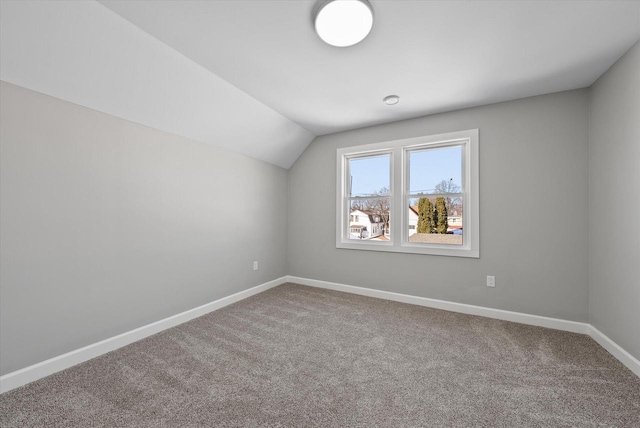 bonus room featuring lofted ceiling, carpet, and baseboards