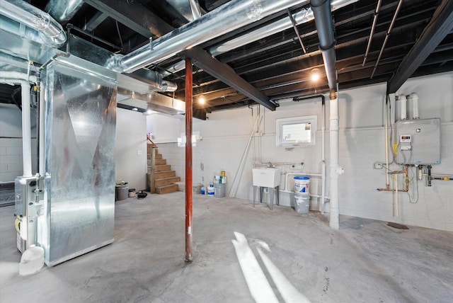 basement featuring concrete block wall, heating unit, water heater, a sink, and stairs