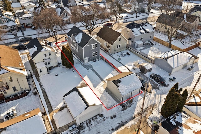 snowy aerial view featuring a residential view