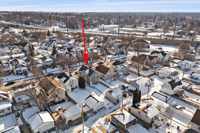 snowy aerial view featuring a residential view