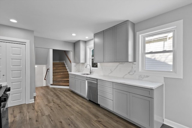 kitchen featuring a sink, gray cabinets, and dishwasher