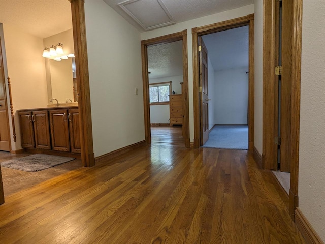 corridor featuring dark wood finished floors and a textured ceiling