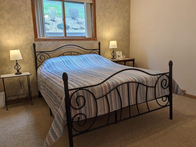 carpeted bedroom featuring baseboards