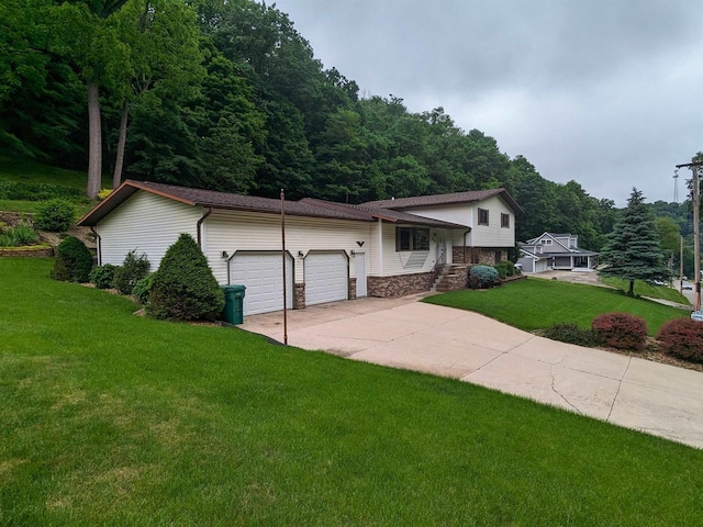 view of front of property featuring a garage, stone siding, driveway, and a front lawn