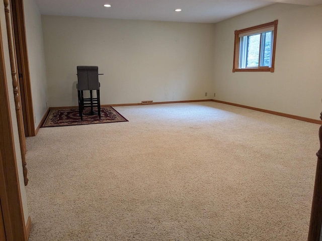 carpeted spare room featuring baseboards and recessed lighting