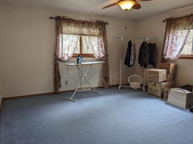 unfurnished bedroom featuring baseboards, a ceiling fan, and carpet flooring