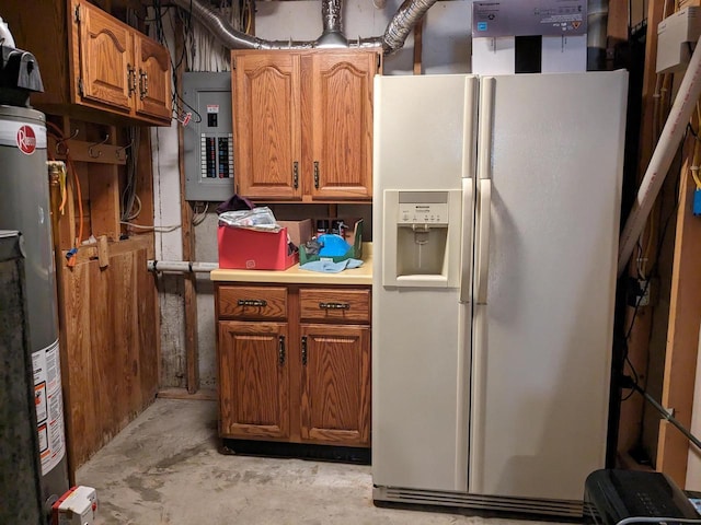 kitchen featuring electric panel, white refrigerator with ice dispenser, brown cabinets, and light countertops