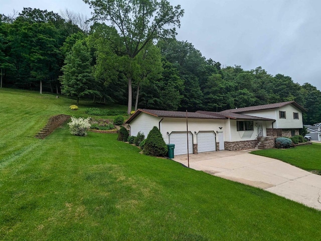 view of front of property featuring a garage, stone siding, concrete driveway, and a front yard