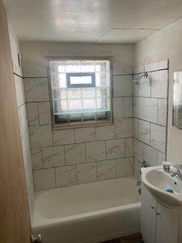 bathroom with plenty of natural light, vanity, and shower / bathtub combination