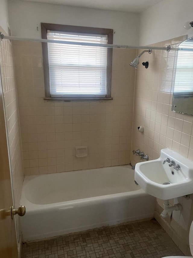 full bath with shower / washtub combination, tile patterned flooring, and a sink