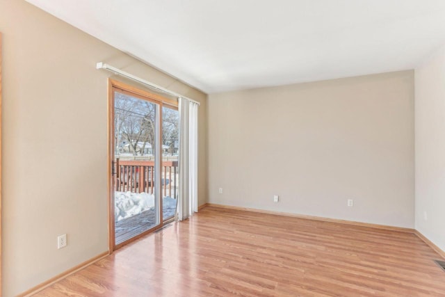 unfurnished room featuring light wood-style floors and baseboards