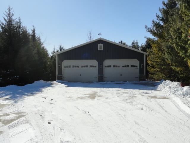 N5194 Blue Valley Rd, Hartford, WI 53027 - snow covered garage with a detached garage