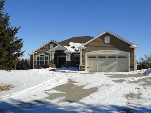 N5194 Blue Valley Rd, Hartford, WI 53027 - view of front of home featuring stone siding and a garage