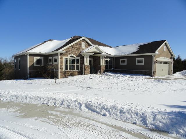 N5194 Blue Valley Rd, Hartford, WI 53027 - view of front of property with stone siding and a garage