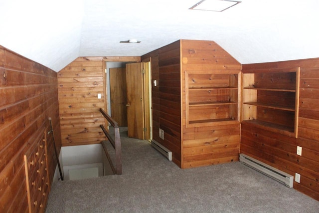 bonus room featuring a baseboard radiator, wooden walls, vaulted ceiling, and carpet flooring