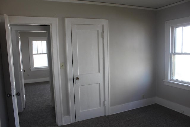 interior space with carpet floors and baseboards