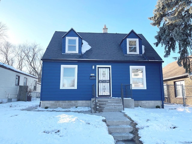 view of front of home featuring roof with shingles, fence, and a chimney