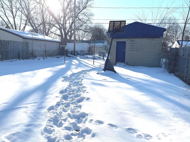 yard covered in snow featuring fence