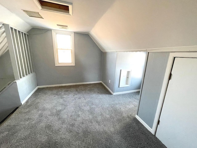 bonus room with lofted ceiling, carpet floors, and baseboards