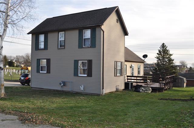 view of property exterior with central air condition unit and a yard