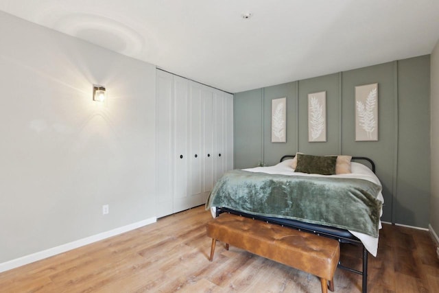 bedroom featuring baseboards and wood finished floors