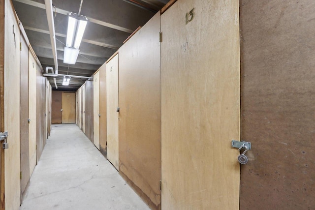 hall featuring unfinished concrete flooring