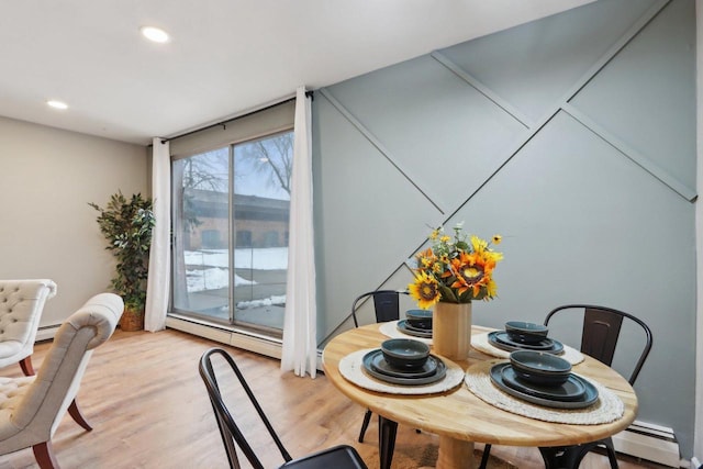 dining area with light wood finished floors, a baseboard radiator, and recessed lighting