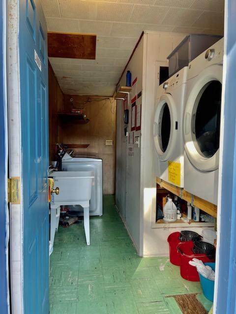 laundry room featuring laundry area, light floors, and separate washer and dryer