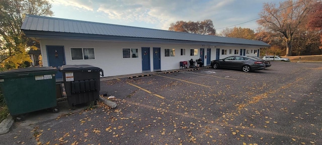 exterior space with uncovered parking and metal roof