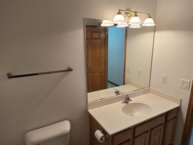 bathroom with toilet and vanity