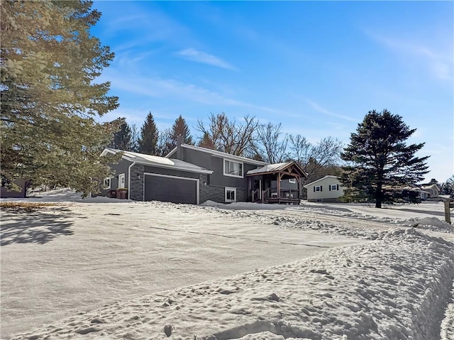 view of front of home with stone siding and an attached garage