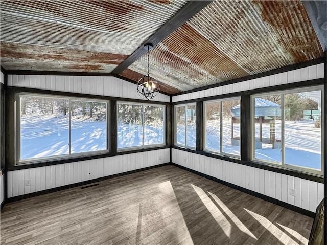 unfurnished sunroom with lofted ceiling, visible vents, plenty of natural light, and an inviting chandelier