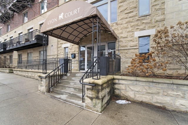 view of exterior entry featuring stone siding