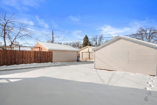 exterior space with fence and an outbuilding