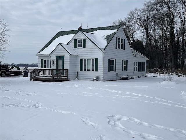 view of front of home with a deck, metal roof, and a standing seam roof