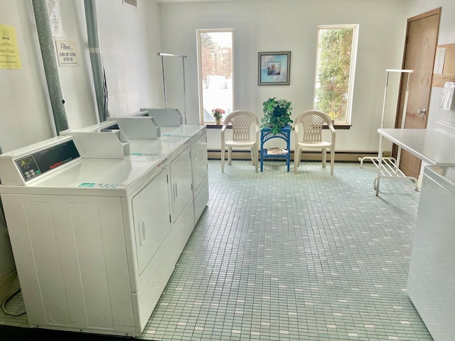 community laundry room featuring plenty of natural light, light tile patterned floors, independent washer and dryer, and visible vents