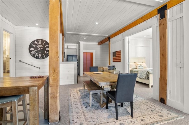 carpeted dining space with recessed lighting, wooden ceiling, and a barn door