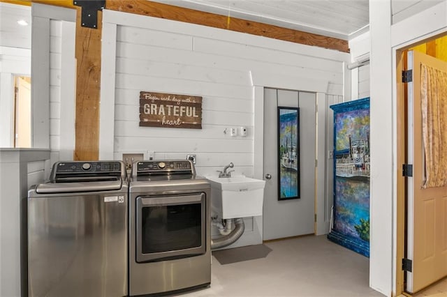 washroom featuring independent washer and dryer and a sink