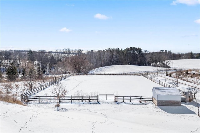 snowy yard with a rural view