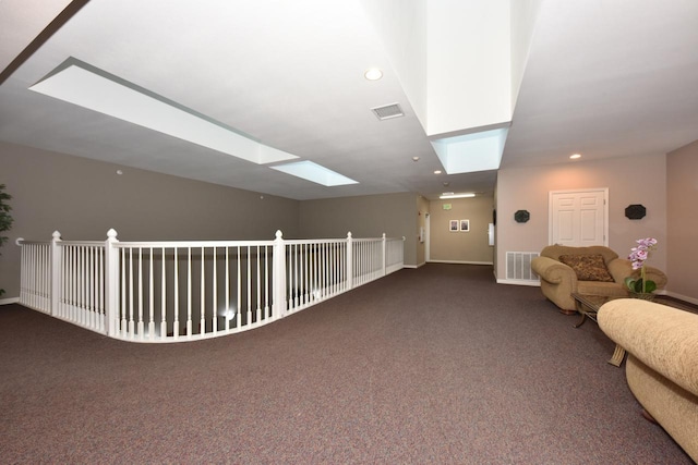 interior space with a skylight, visible vents, carpet, and recessed lighting