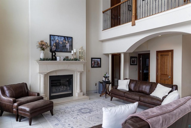 7926 S County Rd A, Superior, WI 54880 - tiled living area featuring arched walkways, a towering ceiling, ornate columns, and a premium fireplace
